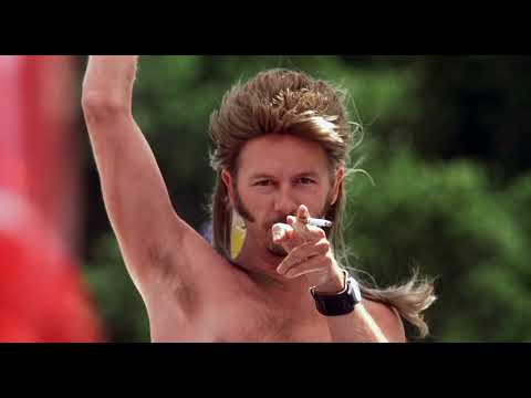 Trailer close-up: Joe Dirt framed against highway sky, music swelling toward the chorus