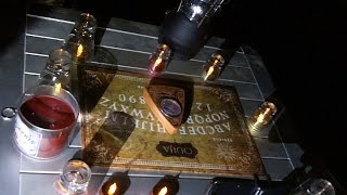 Calling up Satan with a Ouija Board in the Cemetery on Halloween