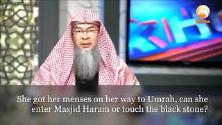 She got her menses on her way to Umrah, can she enter Masjid Haram or touch the black stone?