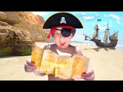 Child on a sunny beach looking at a folded map, wearing a pirate hat and an eyepatch, with a pirate ship in the distance.