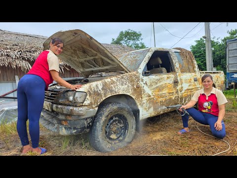 The girl repairs and restores an old scrap pickup truck that was heavily flooded.