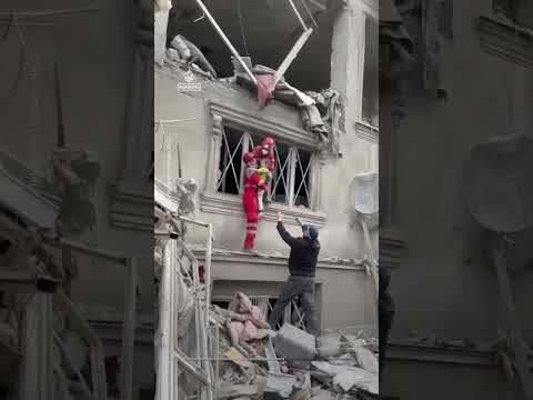 A child and his father pulled from the rubble after US-Israeli strikes