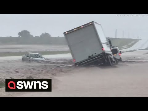Huge flash flood on Texas highway leaves truck stuck partially submerged in gushing rainwater | SWNS