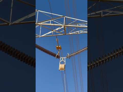 The running board passes through travelers, ensuring precision in power line #PowerLineConstruction