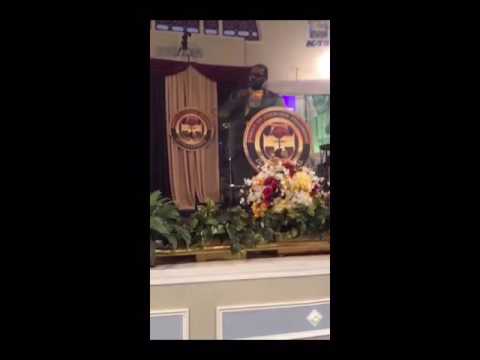 BISHOP NEAL ROBERSON of The Family of Churches Fellowship International singing with his harmonica