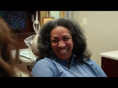 Dental patient laughing while visiting their Chevy Chase dentist