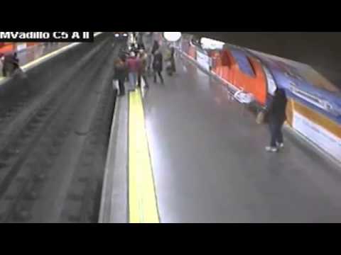 Dramatic footage Woman faints and falls on Madrids Metro rail track YouTube   YouTube
