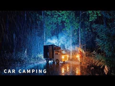 Car camping in heavy rain. Staying cozy with the wood-burning stove inside the car.