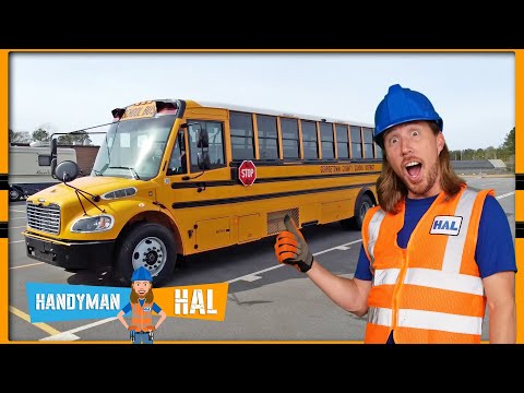 Man in blue hard hat and orange safety vest stands beside a yellow school bus in a parking lot, giving a thumbs-up gesture.
