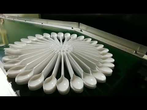 making big spoon.   with robotic machine fully automatic injection moulding machine