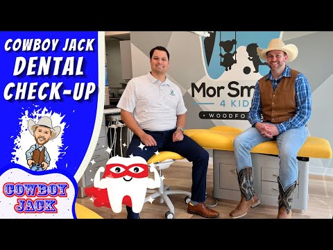 Two men sit on a yellow dental chair in a bright clinic, with a cowboy-themed banner reading 'Cowboy Jack Dental Check-Up' and a cartoon tooth character in front.