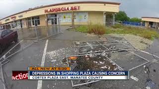 Customers frustrated over large holes in shopping plaza parking lot