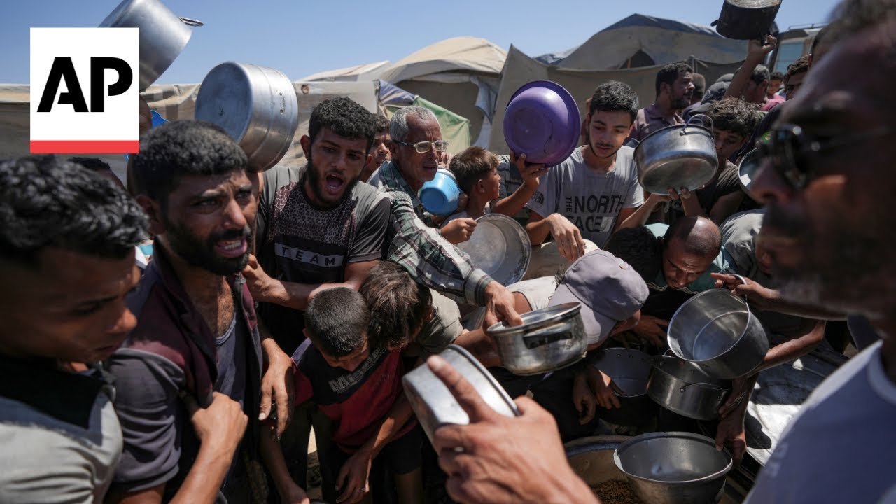 Palestinians desperate to eat crowd around volunteers distributing meals in Gaza