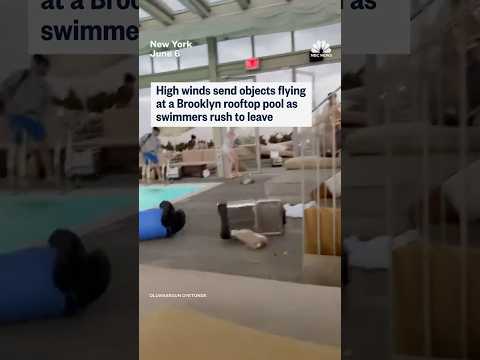 High winds send objects flying at a Brooklyn rooftop pool as swimmers rush to leave