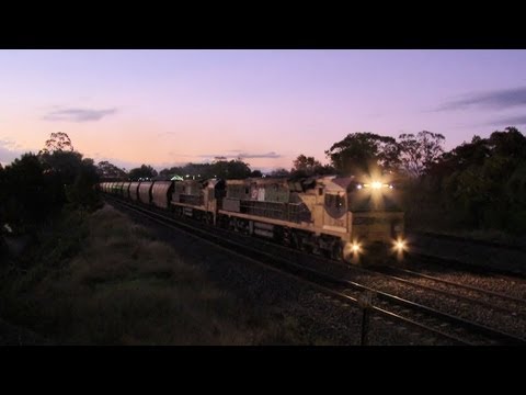 QR National coal train with diesel locomotives at sunset - PoathTV Railroads and Trains