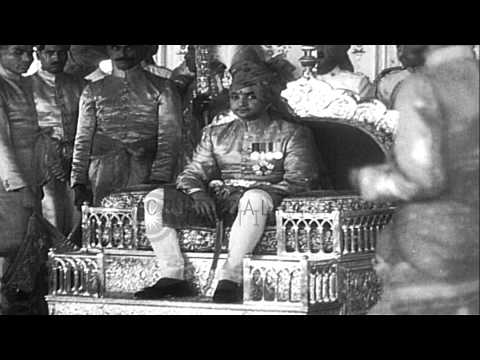 Jaipur Maharajah Sawai Man Singh II sits on his throne and bestows blessings on p...HD Stock Footage