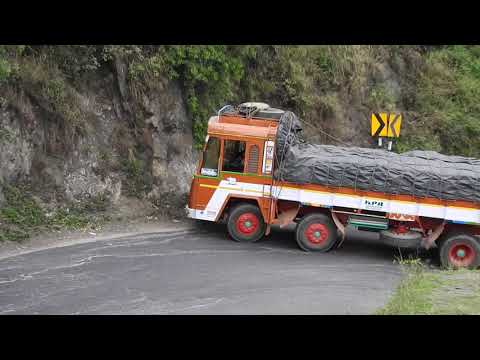 Heavy load lorry uphill turn. Dhimbam ghat