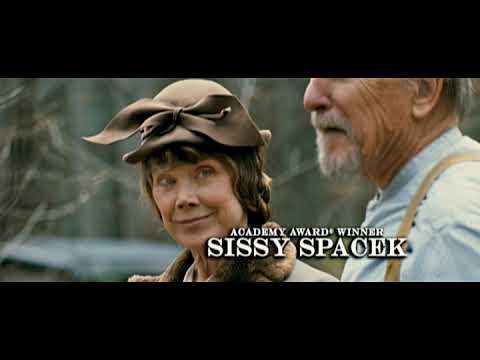 Trailer still of woodland and farmhouse imagery, echoing the dobro-and-fiddle color of the soundtrack