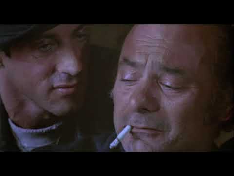 Rocky V (1990) trailer still: Rocky in a gray hoodie staring down a Philadelphia street at dawn