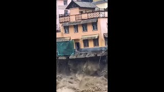China Flood Sends Building Into River