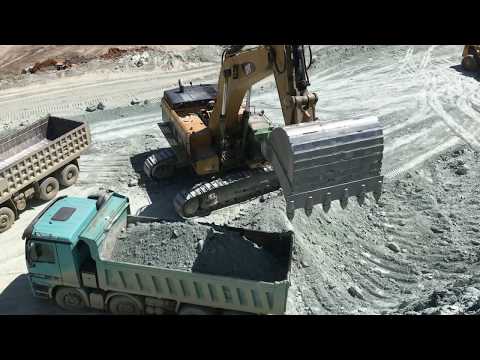 Caterpillar  385C Excavator Loading Trucks