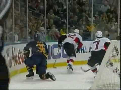 Patrick Kaleta gets a love tap from Mike Fisher, slams into boards