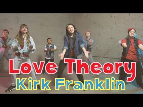 Group of kids dancing in a studio with bold red-and-white title text 'Love Theory' and yellow 'Kirk Franklin' overlay.