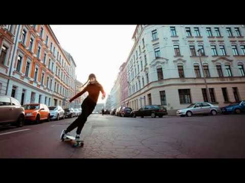 Woman dances gracefully while riding a longboard