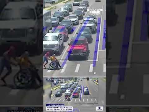 Spider-man helps man in wheelchair cross the street