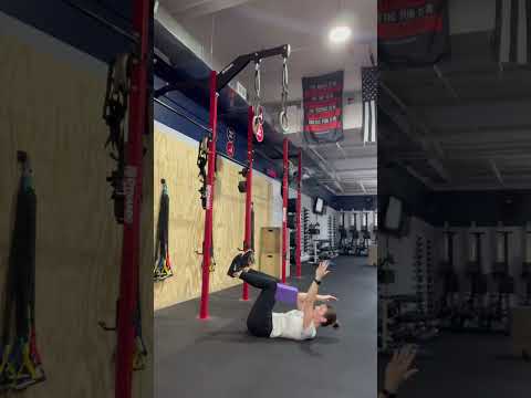 Deadbug with yoga block - hold a block with your opposite knee and elbow, then lower the free leg.