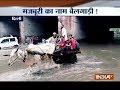 Waterlogging forces public to use bullock cart to cross an underpass in Delhi