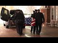 John Dingell's casket put into hearse