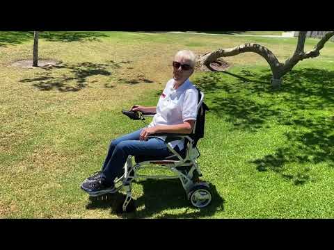 Ranger Discovery Super Lightweight 41 lbs Power Wheelchair up a hill over grass portomobility.com