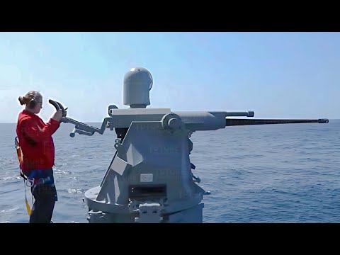 US Navy Female Shows Skill Holding a Mk-38 25mm Chain Gun During Live Fire Exercise
