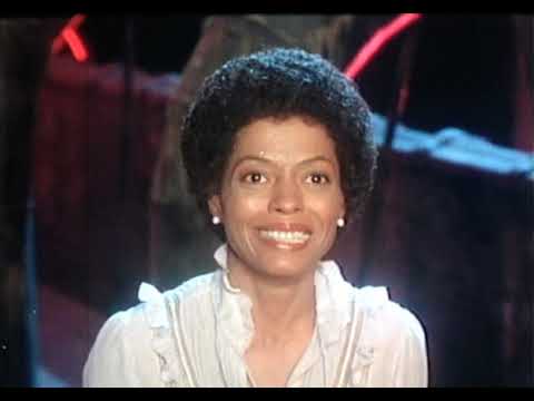 Trailer montage: junkyard poles, yellow brick street, emerald runway — the movie’s major song worlds