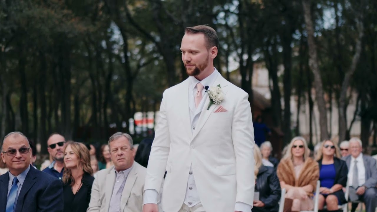 Groom walking down the aisle past seated guests