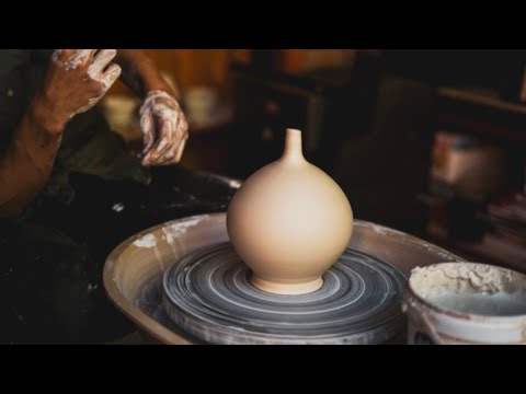 Throwing a thin necked bottle on the pottery wheel