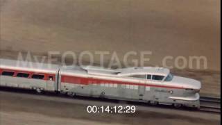 SLEEK TRAIN SPEEDING ACROSS PLAINS TRUCK ON MOUNTAIN CURVE
