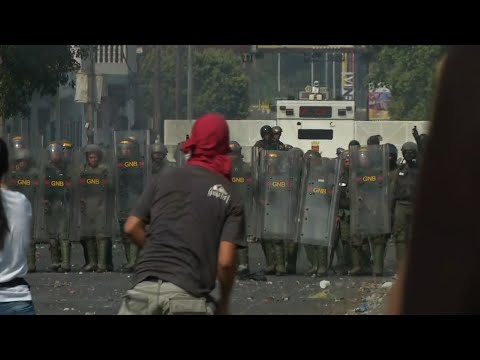 Venezuela's National Guard has fired tear gas on residents clearing a barricaded border bridge between Venezuela and Colombia to let humanitarian aid pass through. (Feb. 23)