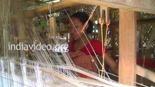Women weaving silk in Sualkuchi, Assam