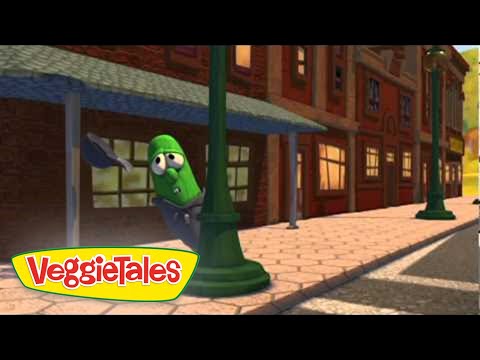 Animated green cucumber character peeks from behind a lamppost on a sunny brick sidewalk, VeggieTales logo in the corner.