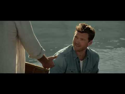 Trailer montage: Mack entering the shack, three hosts at the table, and a sunlit clearing while a song crest builds