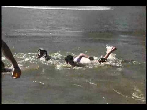 Students break the ice of Lake Mary Nell in Polar Bell Plunge