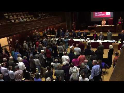 Arlington residents sing the national anthem at Town Meeting
