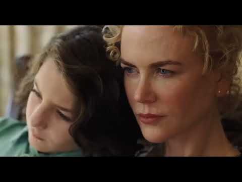Trailer shot: a family frozen in a diner booth, while a choral wall seems to press in