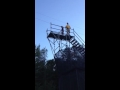 Kid jumping off a 40 foot platform onto an air bag ...