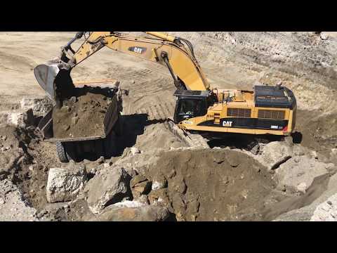 Caterpillar 385C Excavator Loading Caterpillar Dumpers