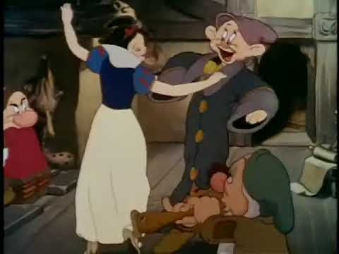 Trailer frame: the dwarfs yodel and dance in the cottage during the Silly Song