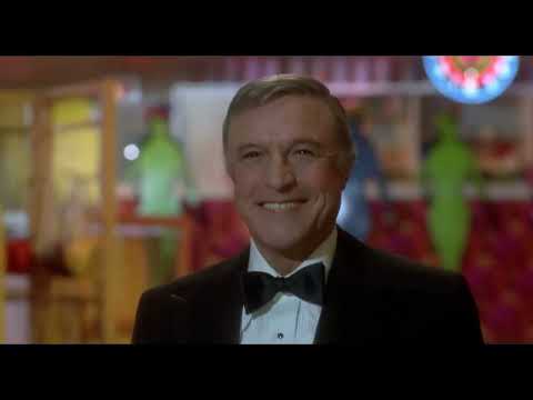 All Over the World montage still: Gene Kelly, ONJ, and Michael Beck in a glitzy store run