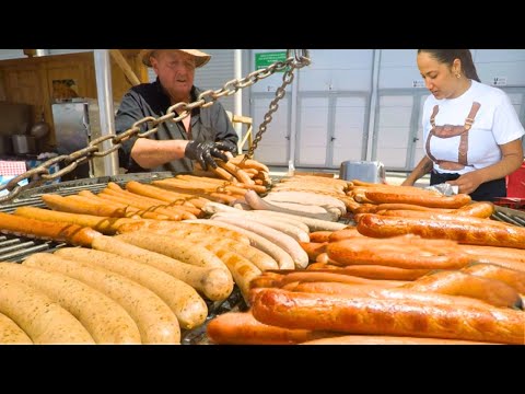 Gigantic Bratwursts on a Circular Grill, Huge Rotisserie, Irish Meat. Street Food Event in Italy